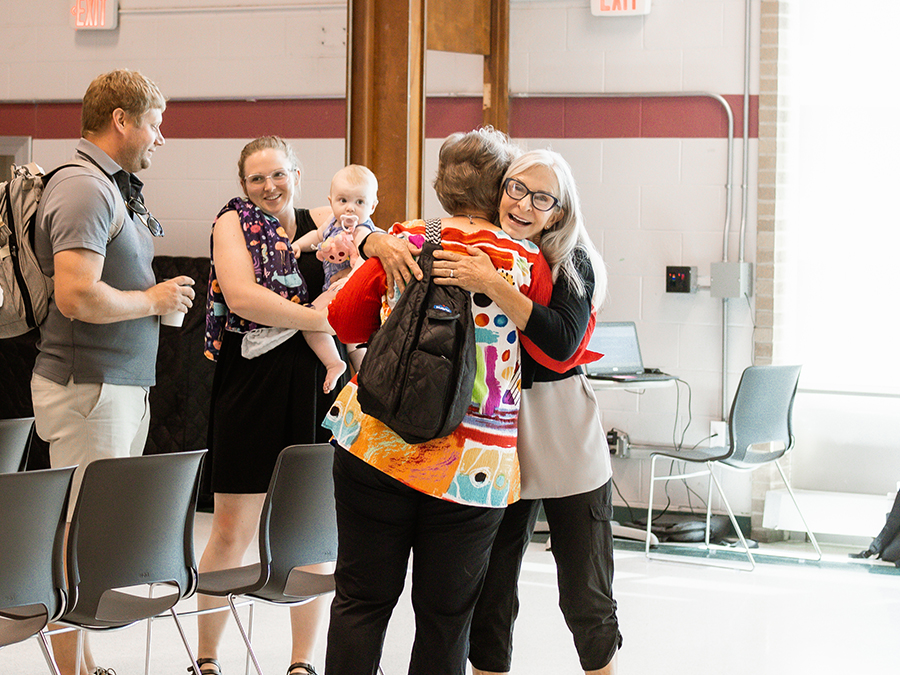 women hugging after a church service