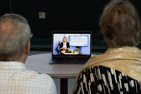 People watching computer screen with online class