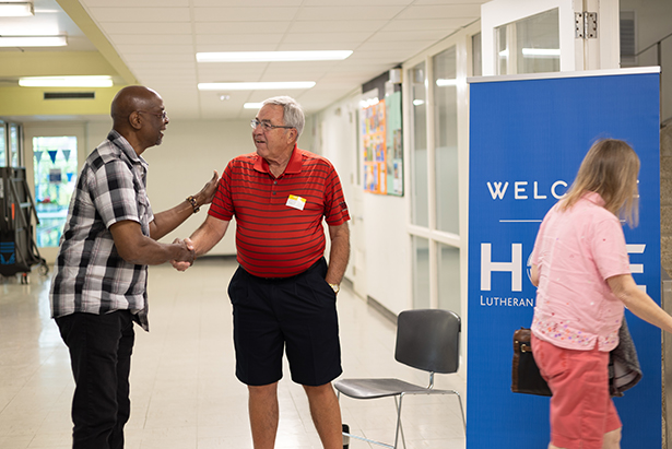 Man greeting at door