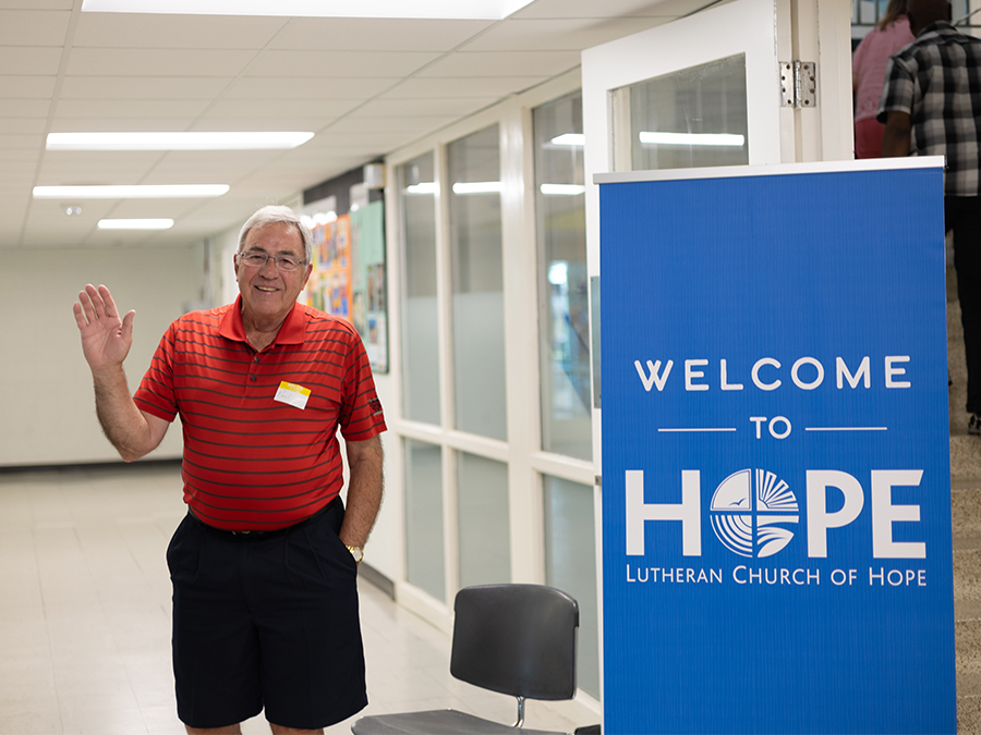 Man greeting as people enter the building