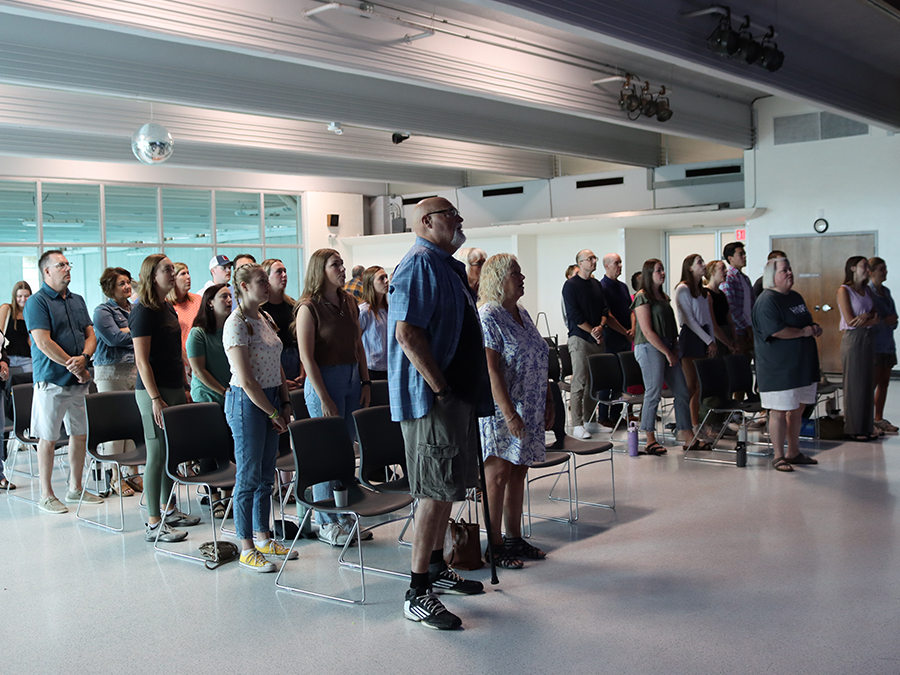 Group worshiping from front of room