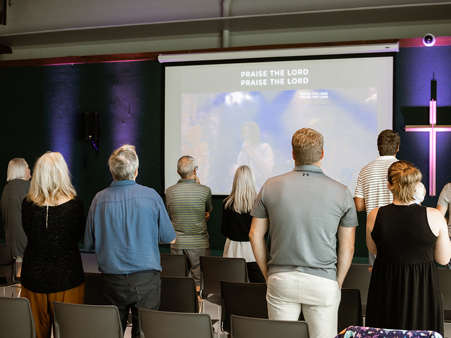 Group worshiping from back of room